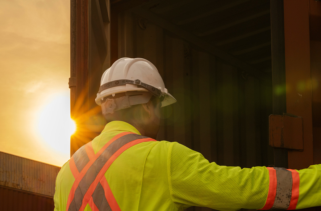Contractor opening a container with tools or construction materials inside.
