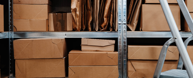 Retail employee organizing seasonal inventory inside an onsite storage container.